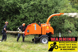 Alternative Product Image: Two people feeding a log into a wood chipper with a "WARNING Moving parts present serious risk to d*cks. DO NOT PUT D*CK IN MACHINERY." sticker overlay.