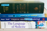 Alternative Product Image: Stack of medical and financial books with prank stickers that read "for vaginal use ONLY" and "for rectal use ONLY".