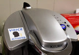 Alternative Product Image: "VOICE ACTIVATED" prank sticker on a Keurig coffee maker.